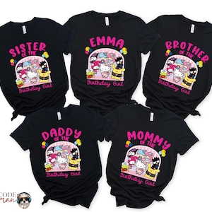 May include: Set of six black t-shirts with a pink and white graphic of cartoon characters and the text "Sister of the Birthday Girl", "Emma Birthday Girl", "Brother of the Birthday Girl", "Daddy of the Birthday Girl", "Mommy of the Birthday Girl".