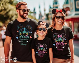 May include: A family of three wearing black t-shirts with a Disney castle graphic and the text "Disney Birthday Girl 2025" with the words "Daddy", "Mommy", and "Auntie" underneath. The shirts feature a Mickey Mouse ear silhouette with fireworks and a pink bow.