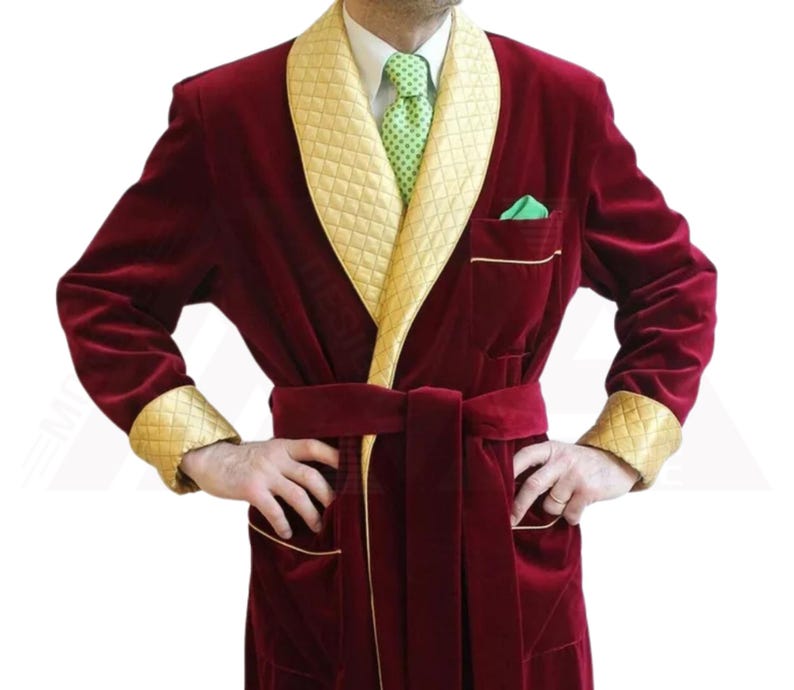 May include: A red velvet robe with gold trim and a shawl collar. The robe has a belt and two pockets.