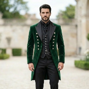 May include: A dark green velvet tailcoat featuring black satin lapels and two vertical rows of silver buttons, worn over a black waistcoat with a silver pocket watch chain, a black shirt, and black trousers.