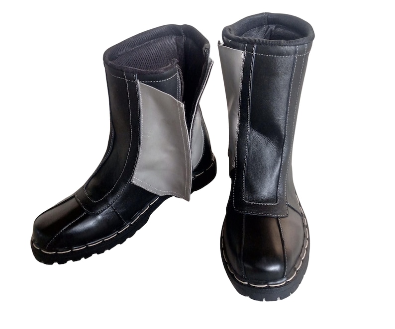 May include: A pair of black leather boots with a zipper on the side. One boot has a gray panel on the side.