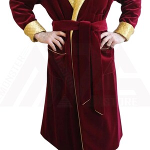 May include: A long, red velvet robe with gold trim and a matching belt. The robe has a shawl collar and two pockets.