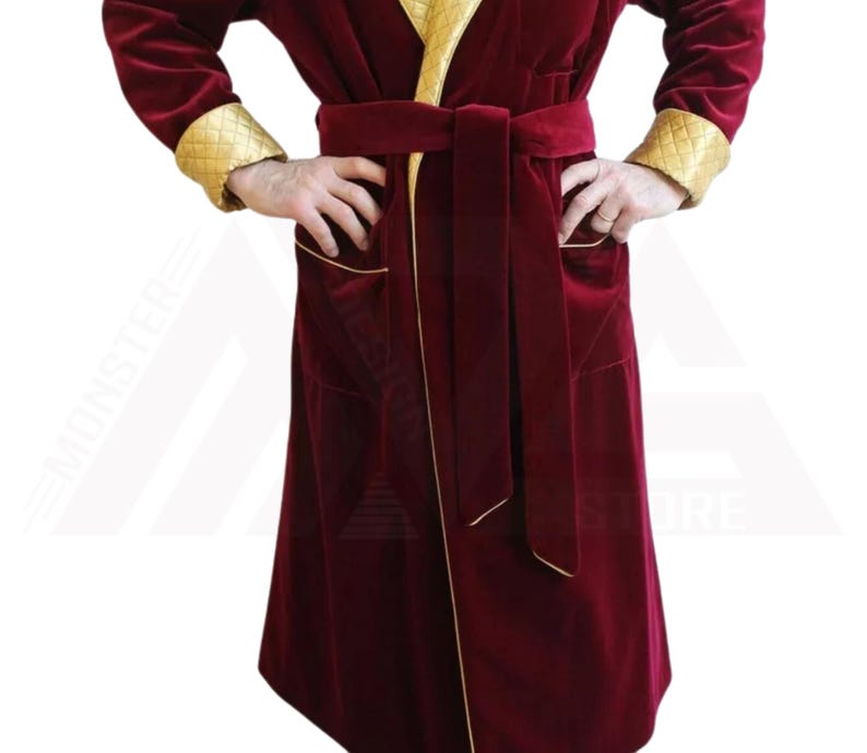 May include: A long, red velvet robe with gold trim and a matching belt. The robe has a shawl collar and two pockets.