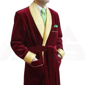 May include: A long, red velvet robe with a gold quilted collar and cuffs. The robe has a sash tie and a single pocket on the left side.