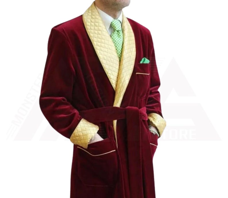 May include: A long, red velvet robe with a gold quilted collar and cuffs. The robe has a sash tie and a single pocket on the left side.