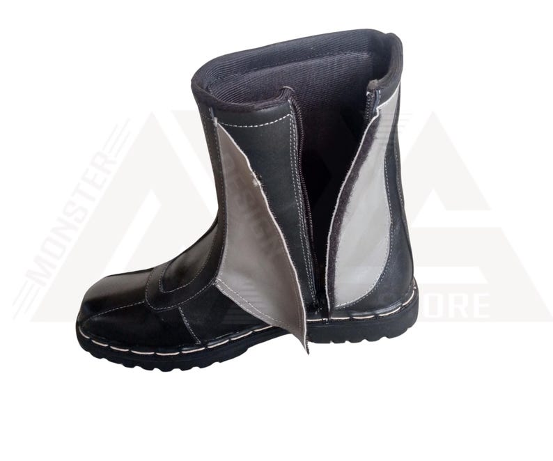 May include: Black leather boots with a zipper up the back and a gray leather panel on the side.
