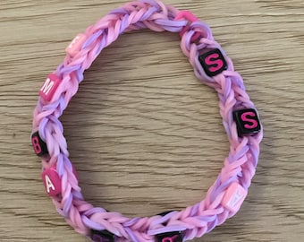 Rosa och lila gummibandsarmband Pinsamt