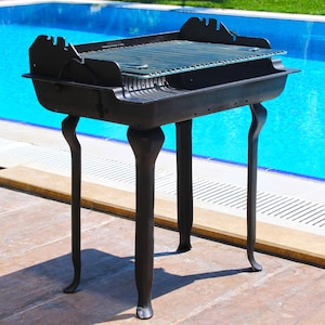 cast iron barbecue with long legs, camping bbq