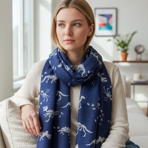 Wrap yourself in prehistoric style with this charming dinosaur skeleton print scarf Featuring an all-over fossil-inspired dinosaur pattern