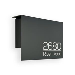 May include: A black metal house number sign with a white background and the numbers 2680 and the text "River Road" in white.