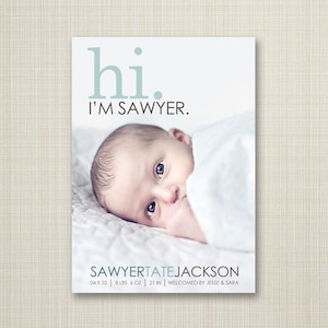 May include: A baby announcement card with a photo of a newborn baby boy. The card says "hi. I'M SAWYER." and includes the baby's name, birthdate, weight, length, and the names of the parents.