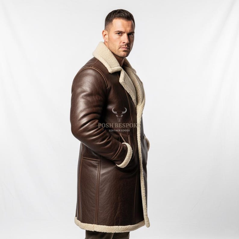 May include: A brown leather coat with a cream-colored shearling lining and trim. The coat has a long length, a notched collar, and pockets. The text "POSH BESPOKE LEATHER GOODS" is visible on the coat.