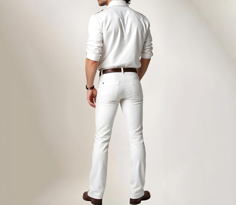 May include: A white button-down shirt with a brown leather belt and white jeans. The person is wearing a white shirt and white jeans.