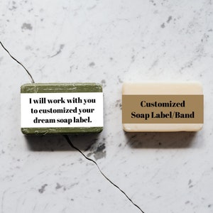 May include: Two bars of soap with labels. The green soap bar has the text "I will work with you to customized your dream soap label." The white soap bar has the text "Customized Soap Label/Band".