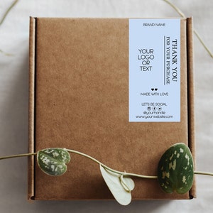 May include: A light blue thank you label with black text. The label says "Thank you for your purchase", "Brand Name", "Your logo or text", "Made with love", "Let's be social", and includes social media icons. The label also includes a website address.