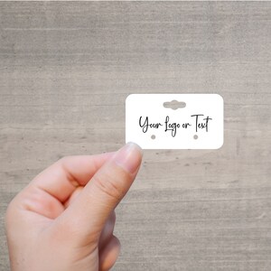 May include: White earring display card with two holes for earrings and a hanging hole at the top. The card has the text "Your Logo or Text" written on it.