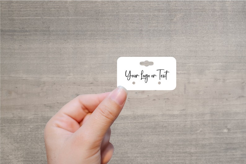 May include: White earring display card with two holes for earrings and a hanging hole at the top. The card has the text "Your Logo or Text" written on it.
