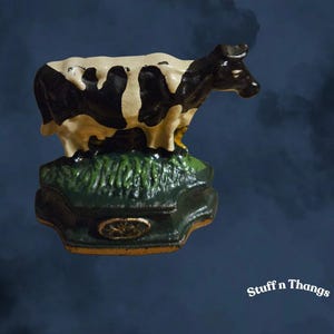 Butoir de porte vintage en fonte pour vache Holstein.