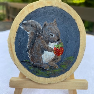 squirrel with a strawberry