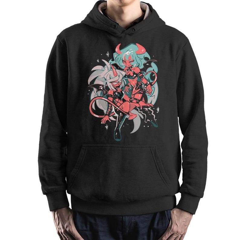 May include: Black hooded sweatshirt featuring a colorful graphic of two anime-style demon characters with horns, wings, and tails. The artwork includes shades of red, blue, and white, set against a gray and black background. The sweatshirt has a front pocket and a drawstring hood.