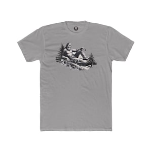 bigfoot sitting in a sexy pose with the forest all around him. Description reads "My eyes are up here"