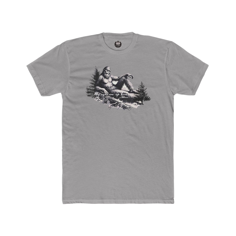 bigfoot sitting in a sexy pose with the forest all around him. Description reads "My eyes are up here"