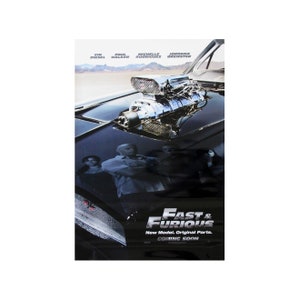 May include: Movie poster for the action film "Fast & Furious" featuring a black car with a large engine and four people standing behind it. The text on the poster reads "Fast & Furious", "New Model. Original Parts." and "Coming Soon".