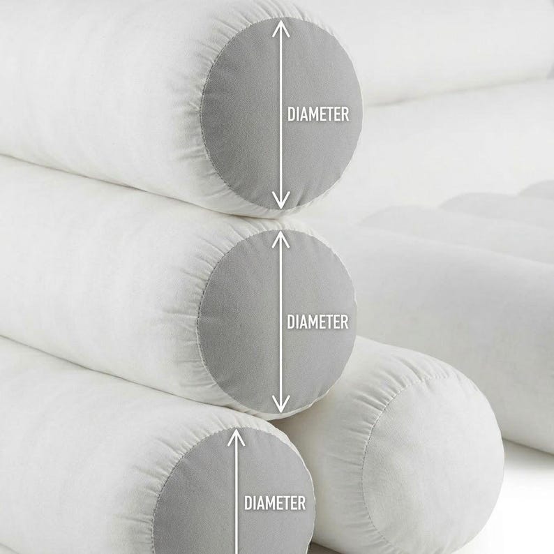 May include: Close-up of white cylindrical pillows with gray end caps. The word "DIAMETER" is printed on the image with a white arrow indicating the measurement. The pillows are stacked on top of each other.