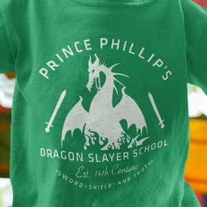 Youth Prince Phillip Dragon Slayer School Shirt | Subtle Vintage Disney Sleeping Beauty Tee | Youth Apparel for Disney Fans