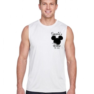 May include: White sleeveless shirt with a black graphic featuring Mickey Mouse ears and the text "Sophia's Dad EST. 2026". The shirt is made of a lightweight material.