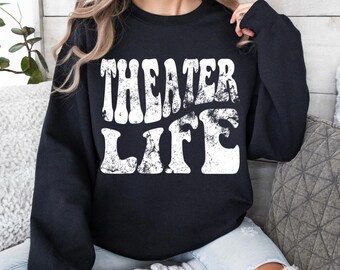 May include: Black sweatshirt with white text that reads "Theater Life" in a retro font.