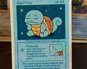 May include: A holographic trading card with a cartoon Squirtle character, labelled "Squirtlazy." The card shows a blue Squirtle with a sad expression. The card's body measurements are 0.5 m in length and 9 kg in weight.