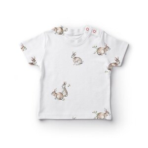 a white t - shirt with rabbits on it