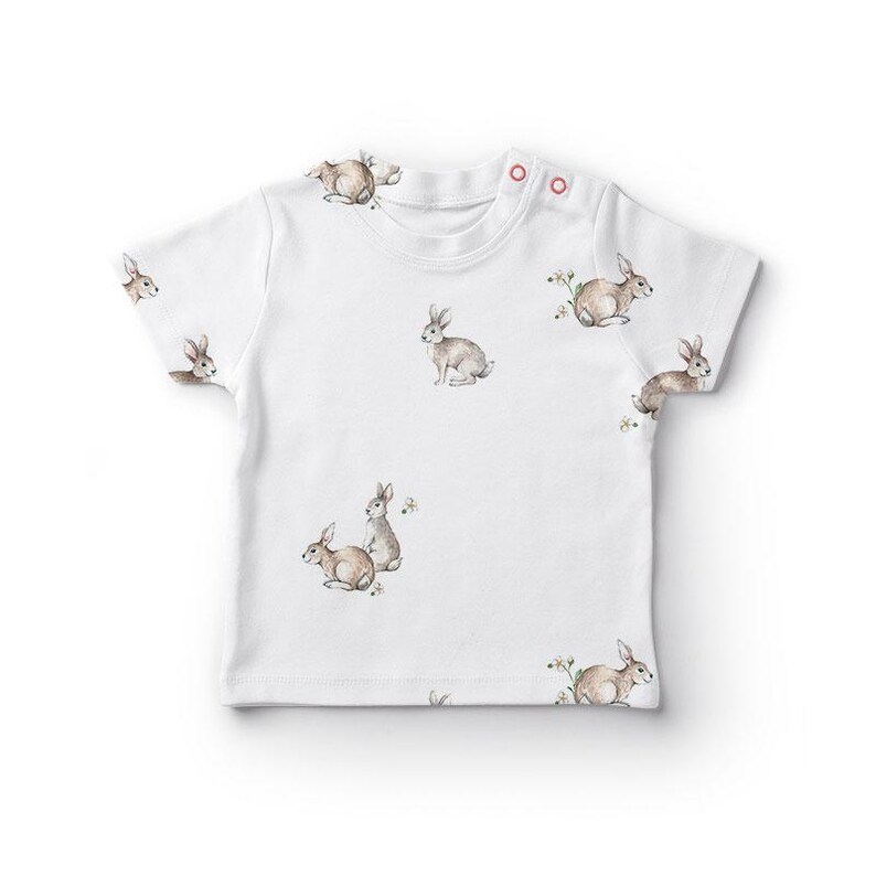 a white t - shirt with rabbits on it