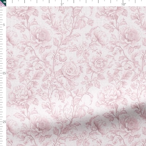 May include: A fabric featuring a repeating floral pattern in pink and white. The design includes large roses and other flowers with detailed leaves and vines. The fabric has a textured appearance, possibly linen or a similar material.