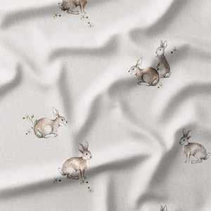 a white fabric with rabbits on it