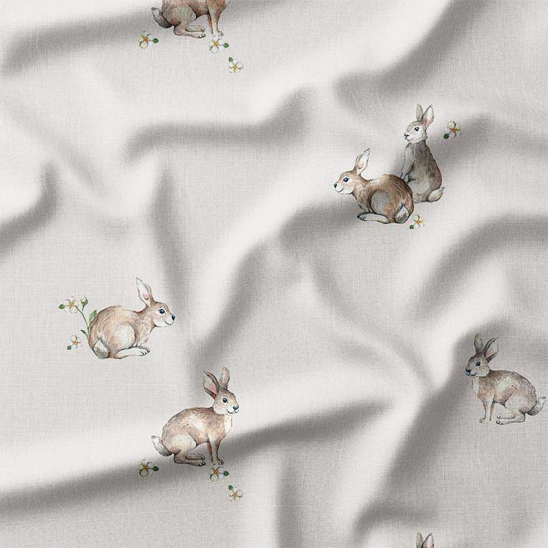 a white fabric with rabbits on it