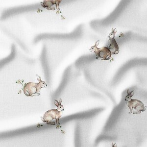 a white fabric with rabbits on it