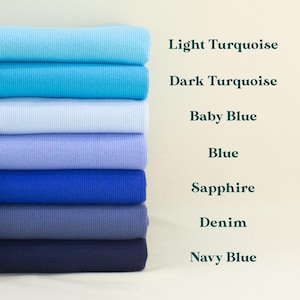 A stack of seven different colored fabric swatches, each labeled with its name: Light Turquoise, Dark Turquoise, Baby Blue, Blue, Sapphire, Denim, and Navy Blue.
