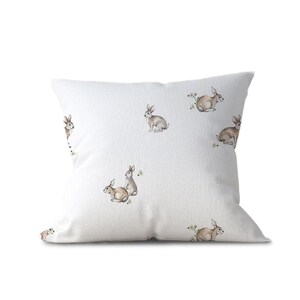a white pillow with rabbits on it