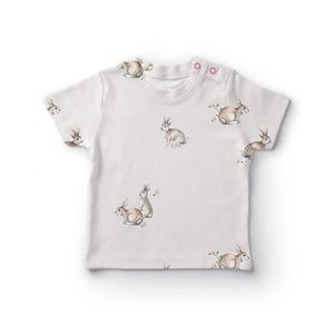 a white t - shirt with rabbits on it