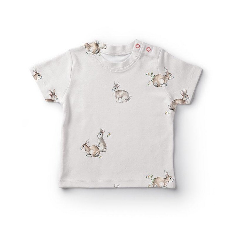 a white t - shirt with rabbits on it