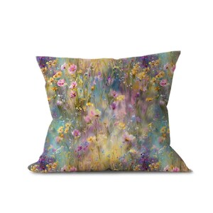 A pillow with a vibrant floral pattern, featuring a variety of colorful flowers and plants.