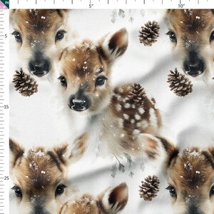 May include: A repeating pattern featuring adorable baby deer with brown fur and white spots, set against a snowy white background. The design includes pine cones and subtle green foliage, creating a wintery, woodland theme.