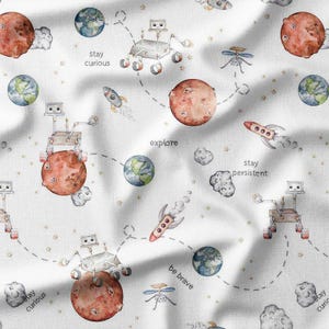 May include: White fabric with a repeating pattern of planets, rockets, and robots. The design includes the phrases "Stay Curious", "Explore", "Stay Persistent", and "Be Brave". The planets are red and blue, and the rockets are red and gray.