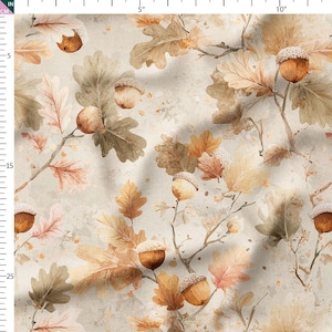May include: Fabric with a watercolor design featuring oak leaves and acorns in shades of brown, beige, and peach. The pattern includes detailed illustrations of leaves and acorns on branches, creating a natural, autumnal theme.