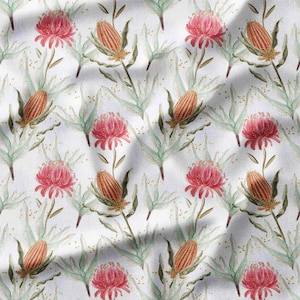 May include: A repeating pattern of watercolor-style flowers and foliage on a white background. The design features pink, red, and orange flowers, along with green leaves and stems. The overall aesthetic is soft and natural, suitable for fabric or wallpaper.