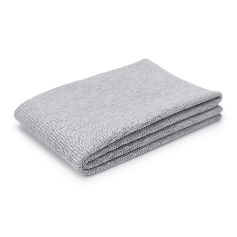 A gray, folded blanket or towel is shown against a white background.