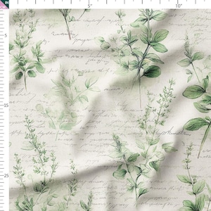 May include: Cream-coloured fabric with a vintage design. It features green botanical illustrations and handwritten script. The design includes various plant sprigs and leaves, creating a classic, elegant look.