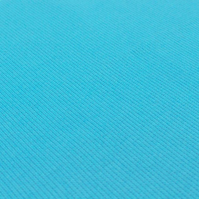 A close-up image of a blue fabric with a diagonal pattern, creating a textured and visually interesting surface.